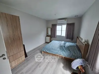 Spacious bedroom with wooden furniture and natural light