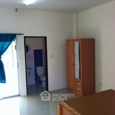 Spacious bedroom with glossy tiled flooring, large windows with natural light, and an en-suite bathroom, ideal for comfortable living.
