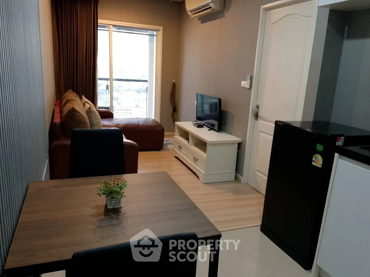 Cozy living room with modern furniture and city view from window.