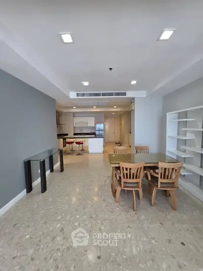 Spacious open-plan living and dining area with modern kitchen and stylish furniture.