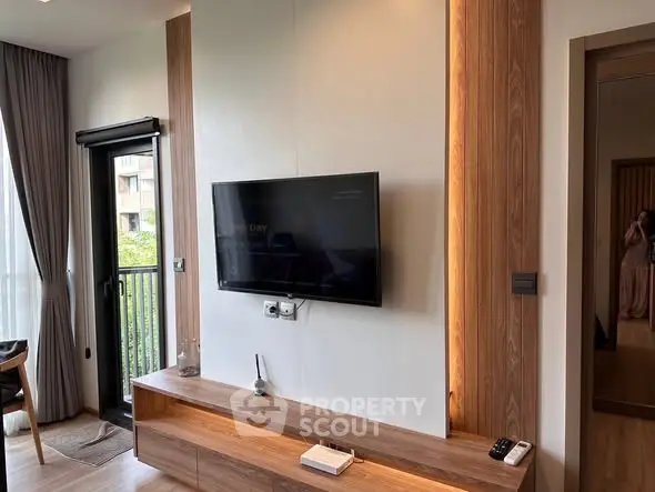 Modern living room with wall-mounted TV and stylish wooden decor