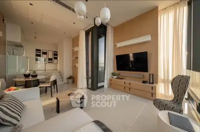 Modern living room with stylish decor and large windows offering natural light