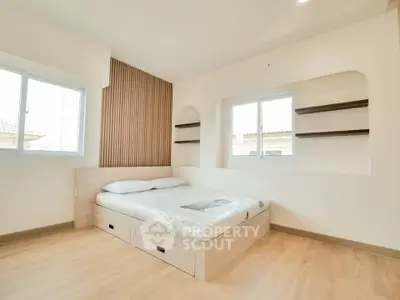 Modern minimalist bedroom with wooden accents and natural light