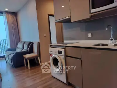 Modern apartment interior with washing machine and cozy living area