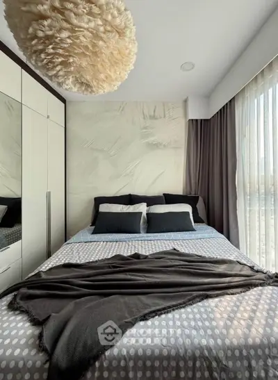 Modern bedroom with stylish decor and large windows for natural light