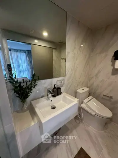 Modern bathroom with sleek fixtures and elegant marble tiles