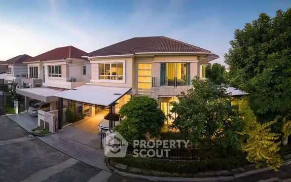 Luxurious two-story house with modern design and spacious driveway in a serene neighborhood.