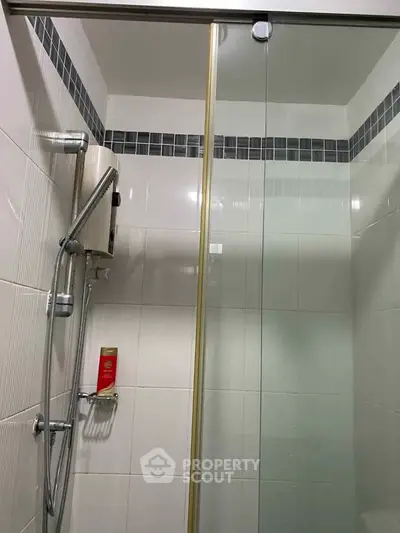 Modern bathroom with glass shower door and sleek tile design