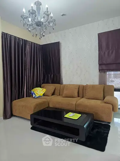 Elegant living room with plush brown sofa and modern chandelier