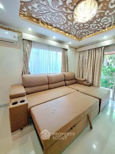 Luxurious living room with elegant ceiling design and plush sofa, perfect for relaxation and comfort.