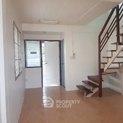 Spacious interior with modern staircase and natural light in a contemporary home.