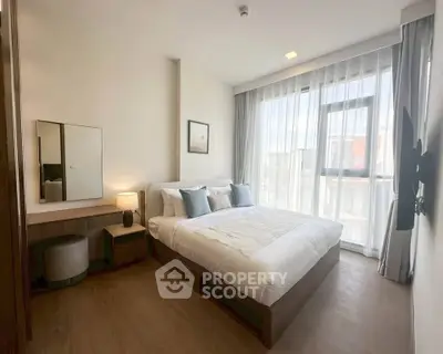 Modern bedroom with large window and stylish decor in a bright apartment