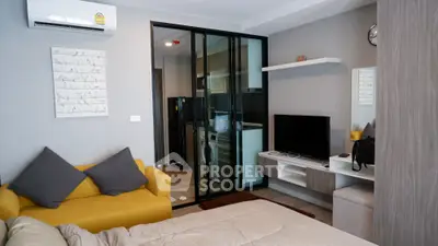 Modern studio apartment with a cozy bedroom area, stylish living space, and a sleek glass partition leading to a sophisticated kitchen.