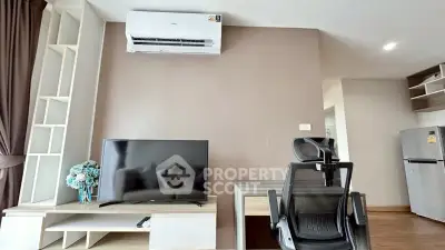 Modern living room with air conditioning, TV, and ergonomic chair in a stylish apartment.