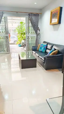Charming living room with sleek leather sofa and modern decor, perfect for relaxation and entertaining.