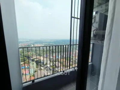 Stunning high-rise balcony view overlooking cityscape and lush greenery, perfect for urban living.