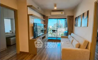 Modern living room with city view, featuring sleek furniture and large windows for natural light.