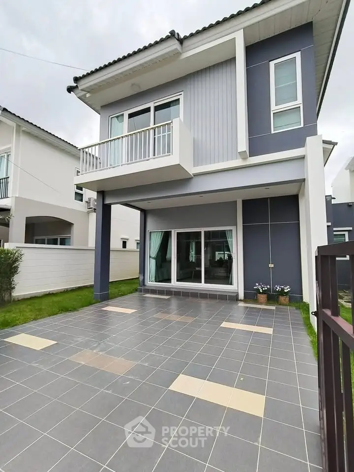 Modern two-story house with stylish facade and spacious tiled driveway