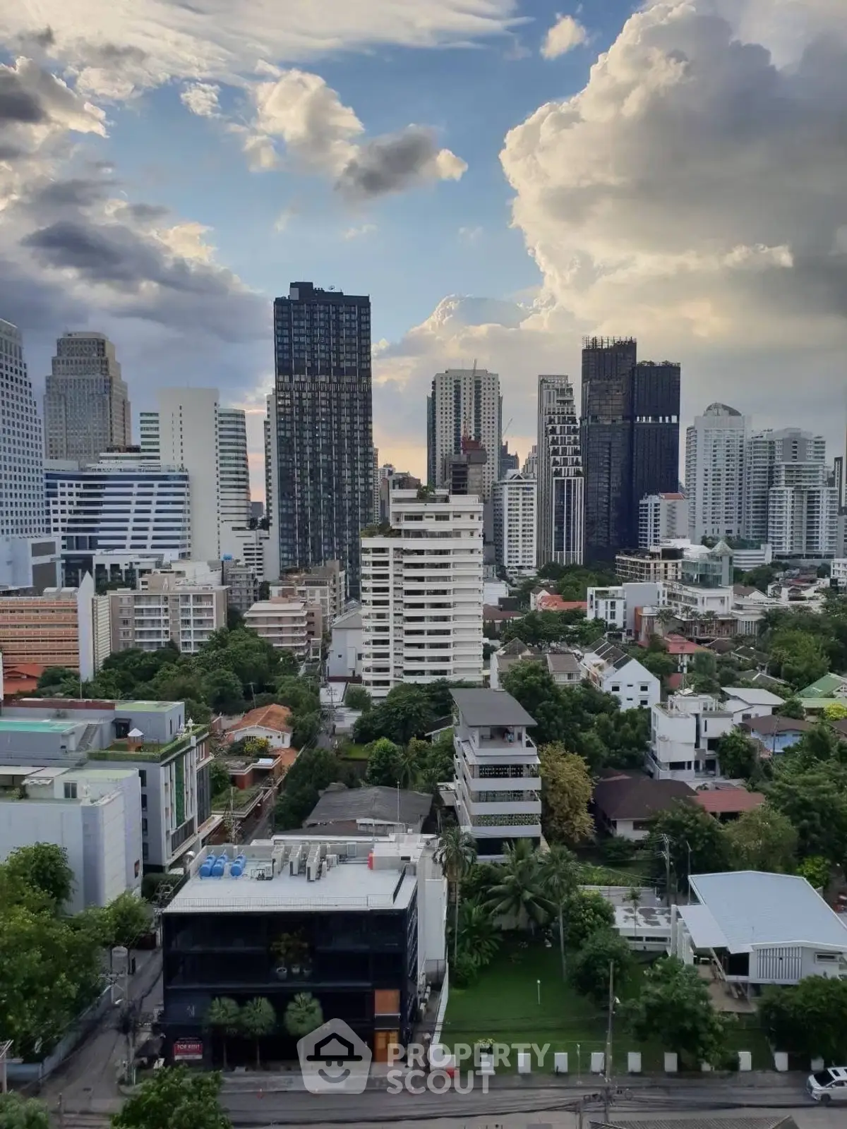 Stunning cityscape view showcasing modern skyscrapers and lush greenery in a vibrant urban setting.