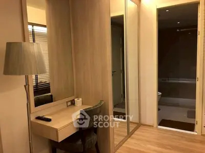 Elegant bedroom with mirrored wardrobe and cozy workspace