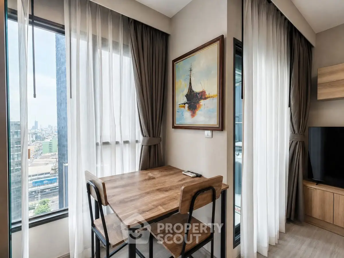 Modern apartment interior with city view, featuring a cozy dining area and stylish decor.