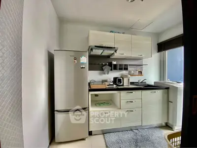 Modern compact kitchen with sleek cabinets and stainless steel appliances