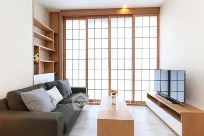 Modern living room with sleek furniture and large windows for natural light.