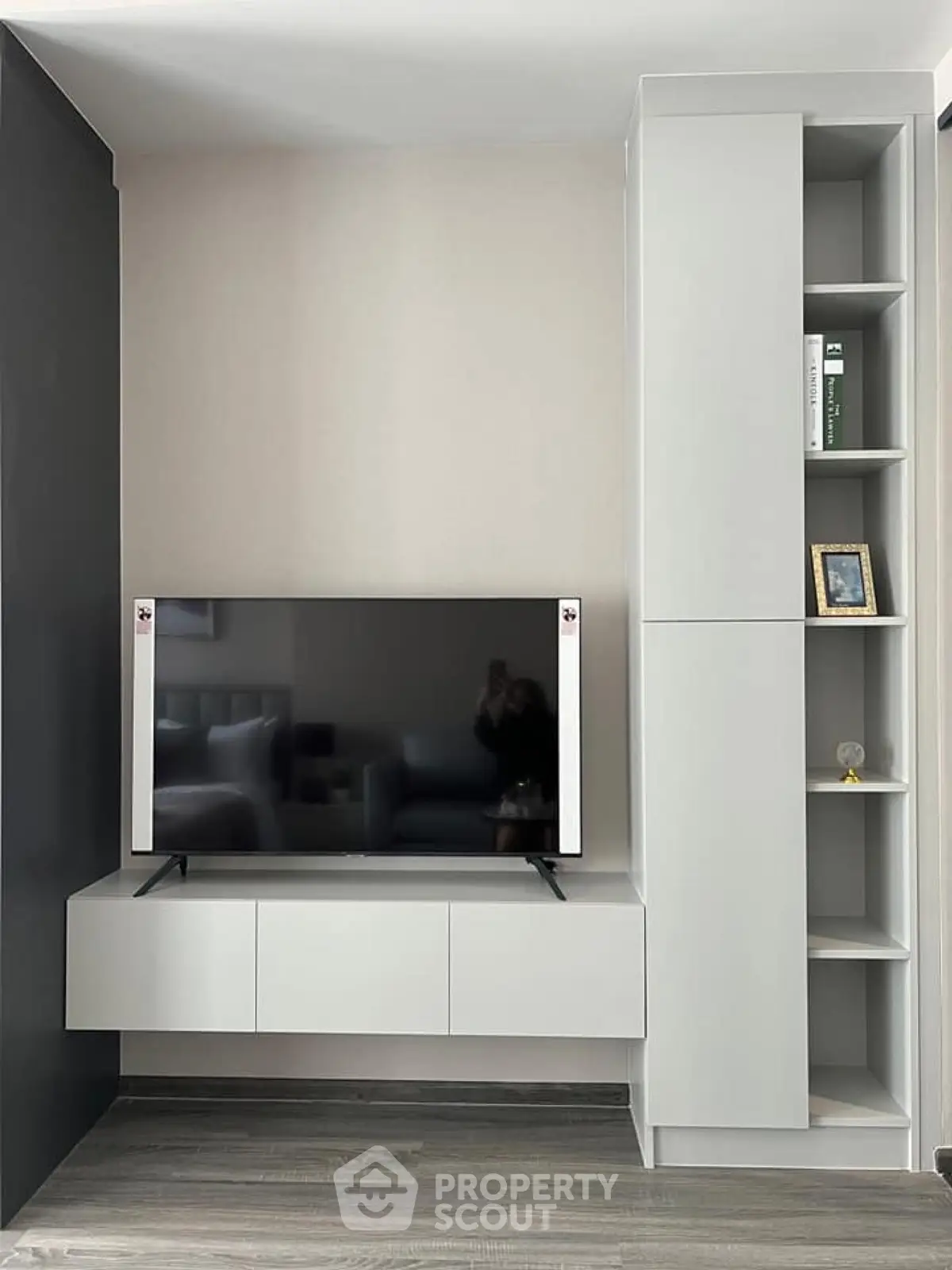 Modern living room with sleek TV unit and minimalist shelving