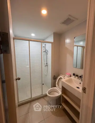 Modern bathroom with glass shower enclosure and sleek fixtures