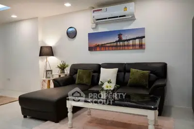 Modern living room with stylish black leather sofa and elegant decor