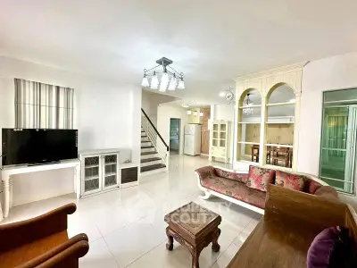 Spacious living room with elegant furniture and open layout, perfect for family gatherings.