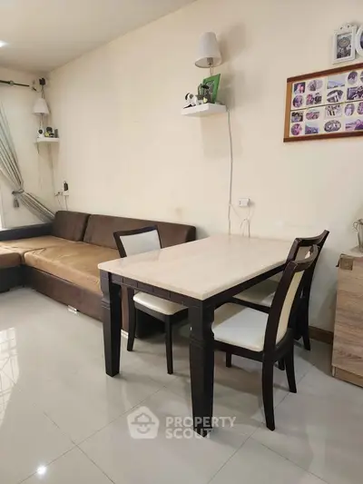 Cozy living room with modern dining set and comfortable sofa, perfect for relaxation and entertaining.