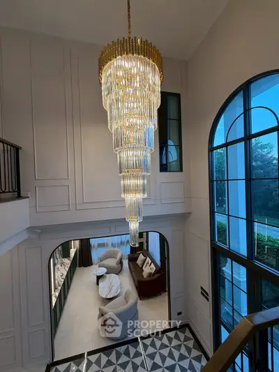 Luxurious living room with grand chandelier and elegant decor