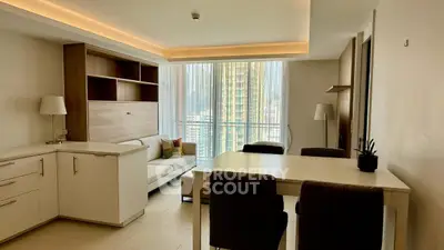 Modern living room with elegant furniture and large windows offering city views.