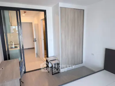 Modern apartment interior with sliding glass doors and built-in wardrobe