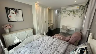 Charming bedroom with elegant decor, featuring a cozy bed, stylish furniture, and artistic wall accents.