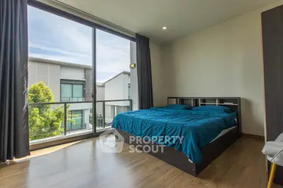 Modern bedroom with large windows and natural light in a contemporary home.