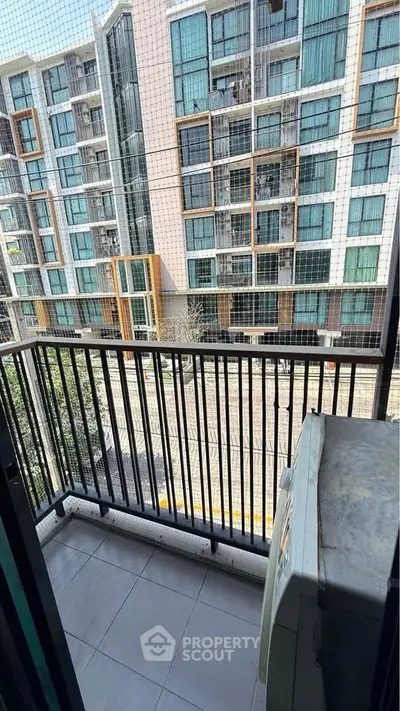 Modern apartment balcony with city view and safety netting, perfect for urban living.