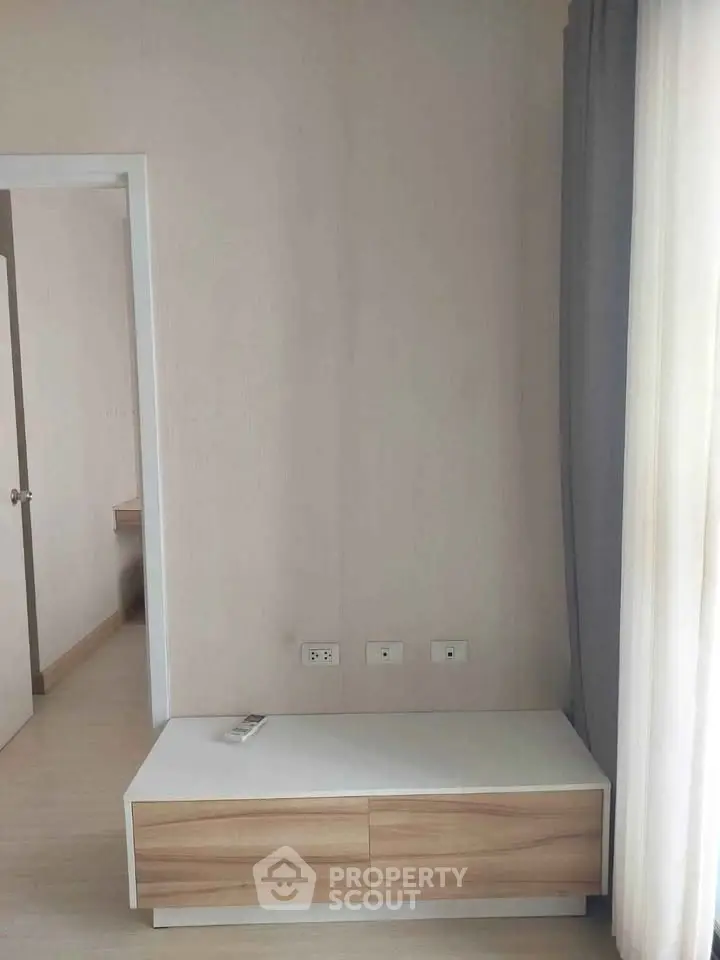 Minimalist interior with light wood furniture and neutral tones, perfect for modern living spaces.