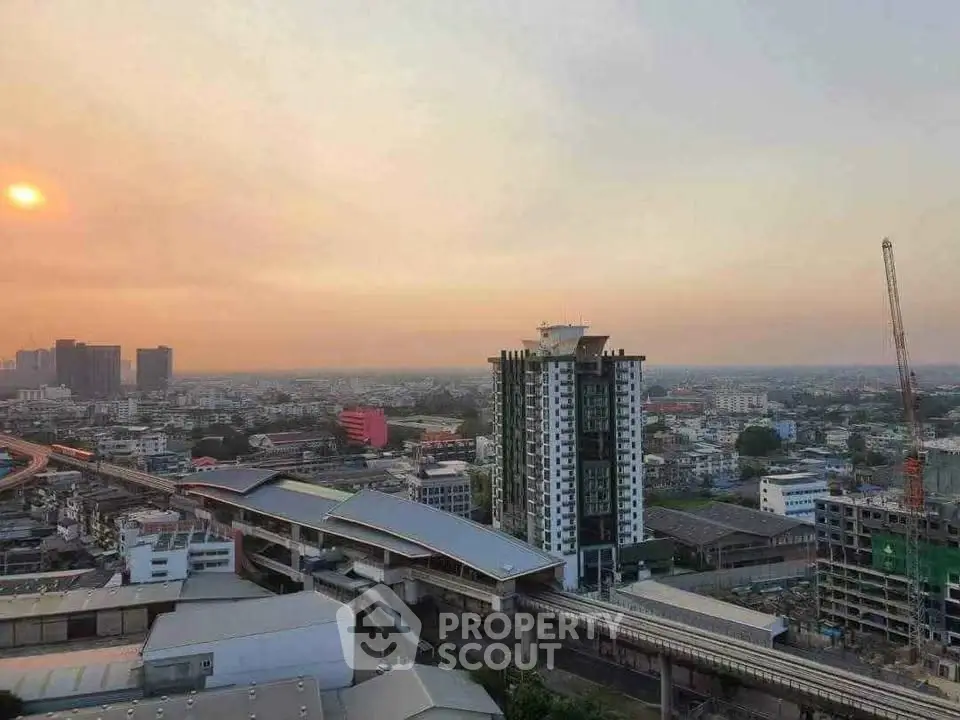 Stunning cityscape view with modern high-rise building and sunset backdrop.