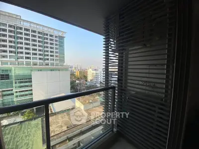 Stunning urban view from a modern apartment balcony with cityscape backdrop.
