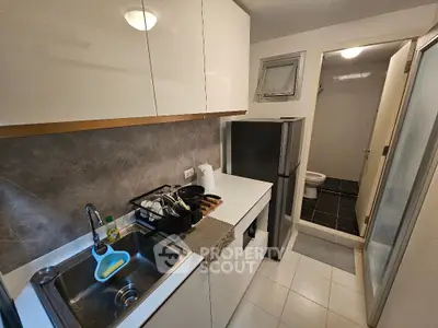 Modern compact kitchen with sleek cabinetry and stainless steel sink