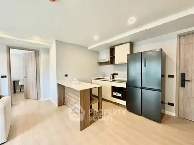 Modern kitchen with sleek appliances and open layout in a stylish apartment.