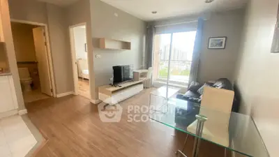 Modern living room with balcony view, sleek furniture, and natural light in a stylish apartment.