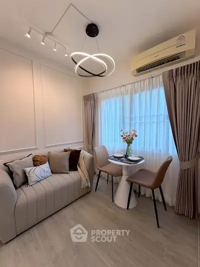 Chic modern living room with stylish lighting and cozy seating area, perfect for relaxation and entertaining.