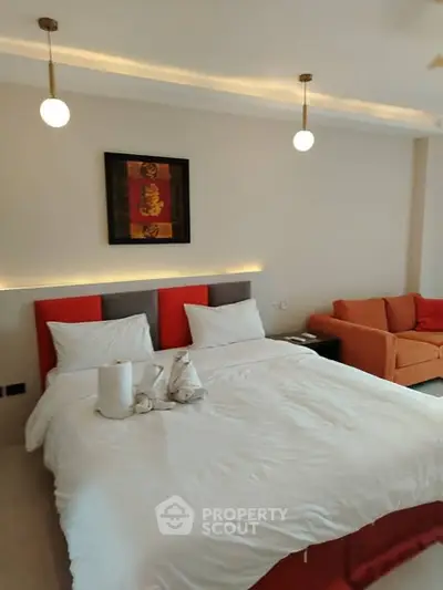 Luxurious bedroom with modern decor and cozy seating area