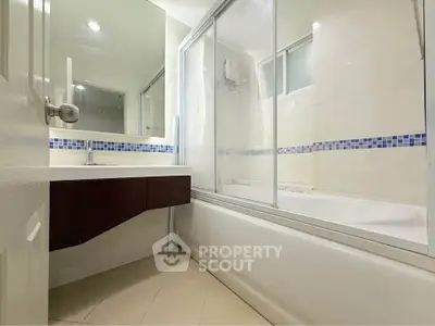 Modern bathroom with sleek design and bathtub in a bright setting.