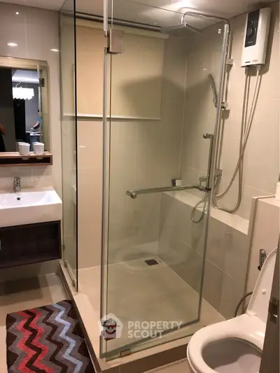 Modern bathroom with glass shower enclosure and sleek fixtures