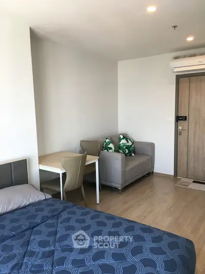 Modern studio apartment with cozy living area and stylish decor