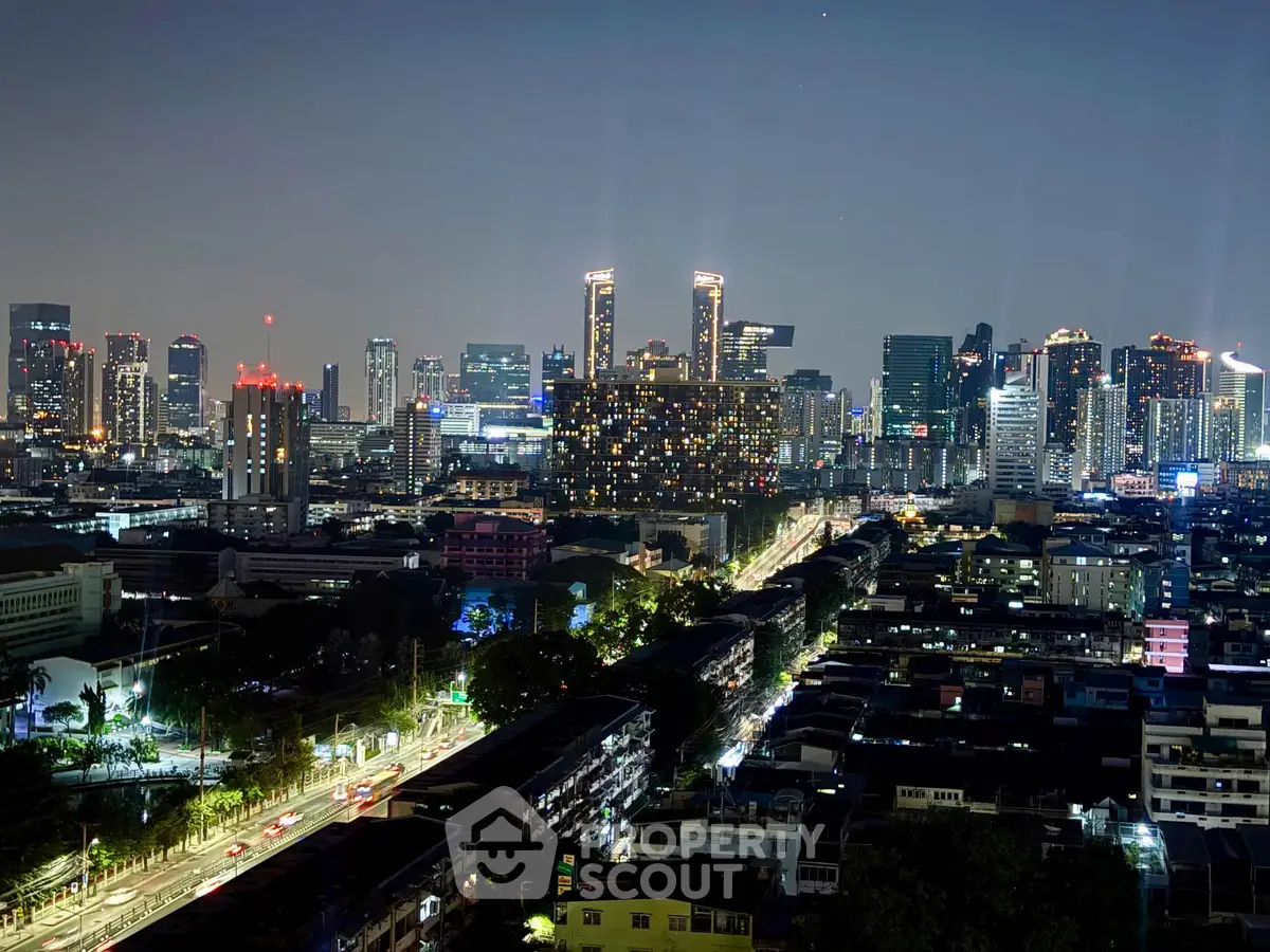 Stunning cityscape view showcasing vibrant urban skyline at night with illuminated skyscrapers.